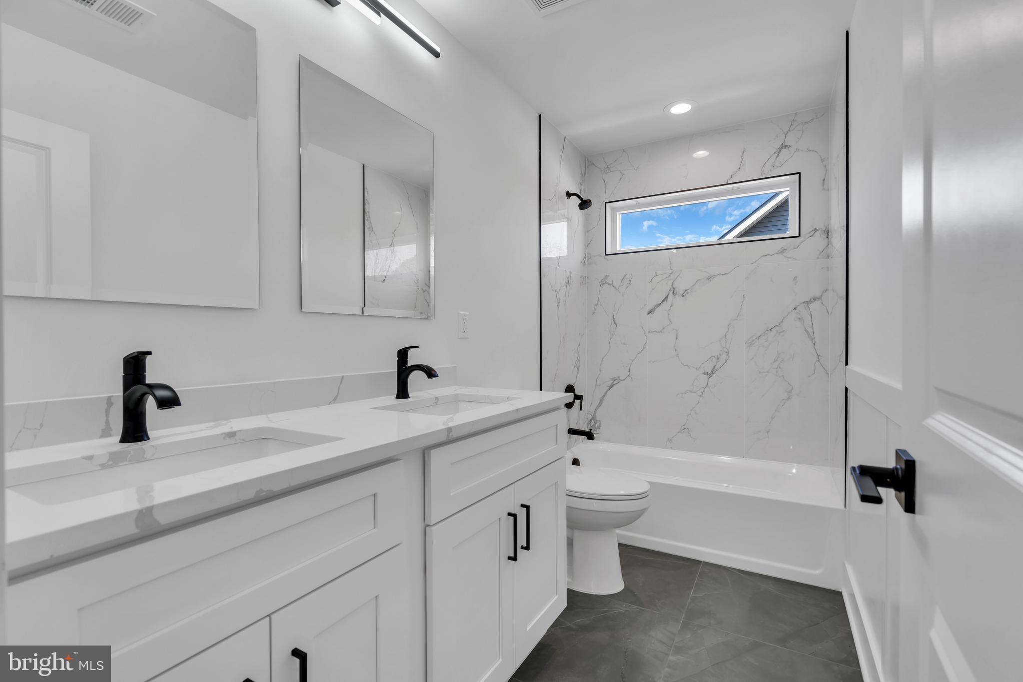 264 Schooner Road Manahawkin, NJ 08050 - Photo 25 of 37 a bathroom with a bathtub shower sink vanity and toilet