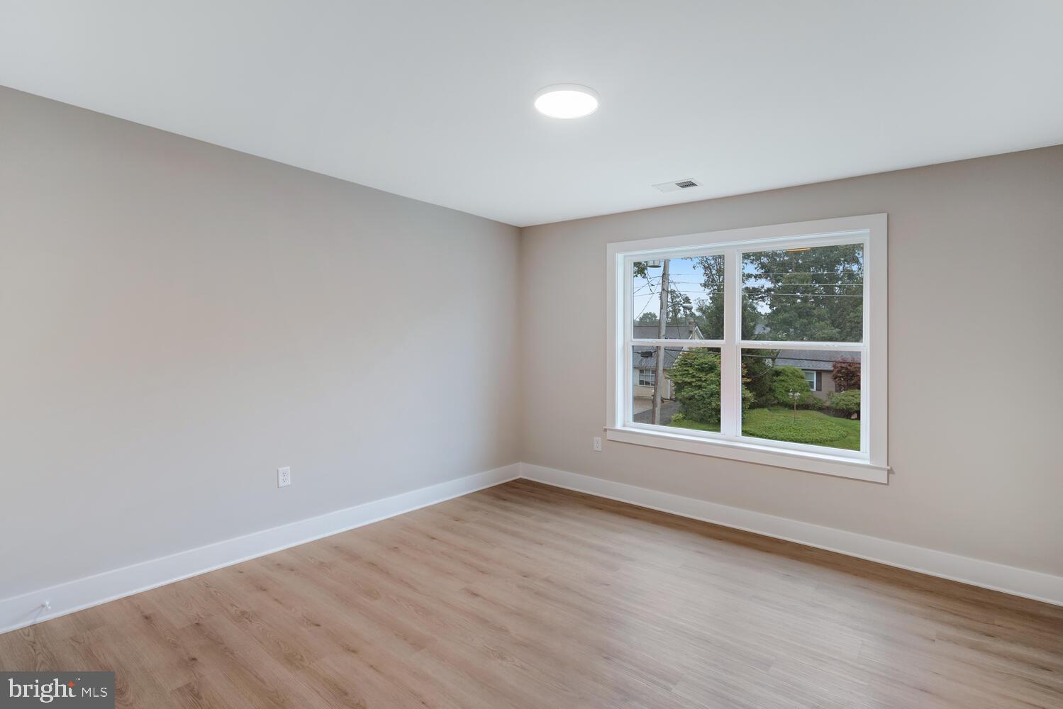 264 Schooner Road Manahawkin, NJ 08050 - Photo 27 of 37 an empty room with wooden floor and windows