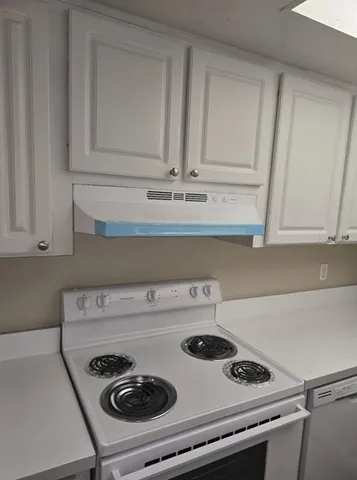 a stove top oven sitting inside of a kitchen