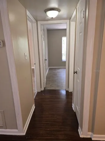 a view of a hallway with wooden floor