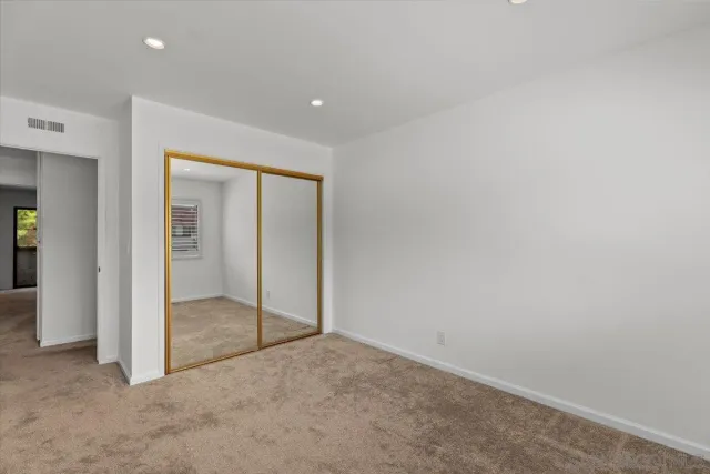 an empty room with sliding glass door