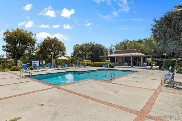 a view of a swimming pool with an outdoor seating
