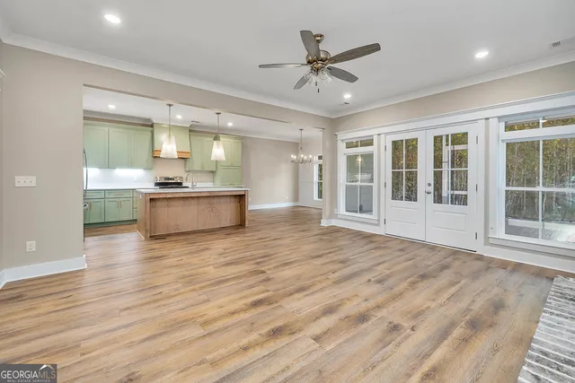 a view of a kitchen with a sink and a large window