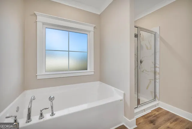 a white bath tub sitting next to a shower