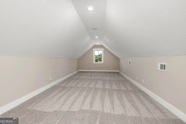 a view of an empty room and a window