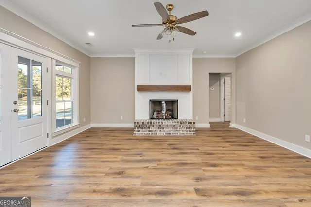 a view of an empty room with window and fire place