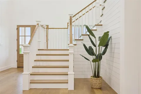 a view of entryway and hall with wooden floor