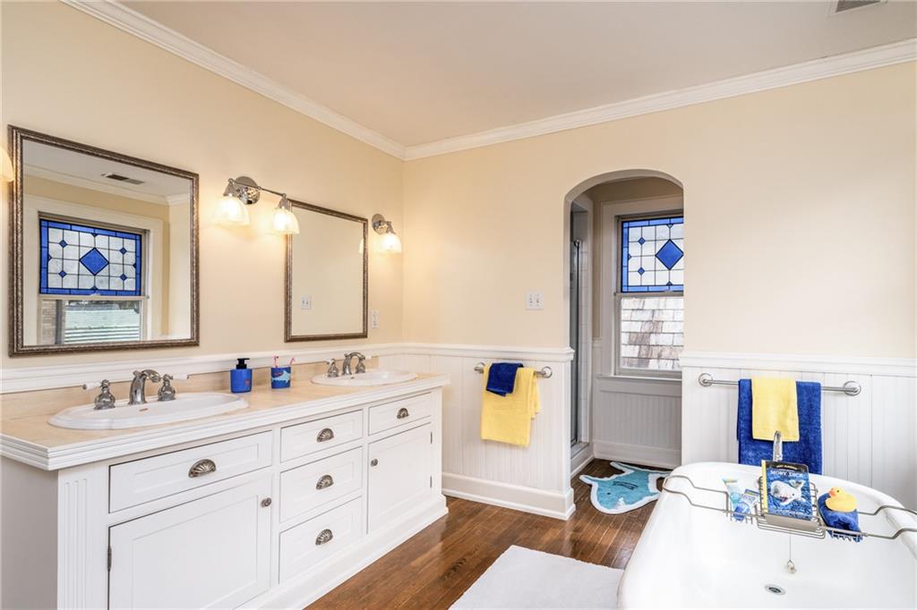 604 Pine Road Sewickley, PA 15143 - Photo 17 of 24 a bathroom with double vanity sinks a mirror and a bathtub