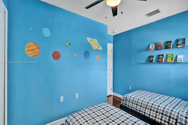 a bedroom with a bed and a wall painting