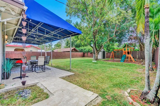 a view of a backyard with sitting area