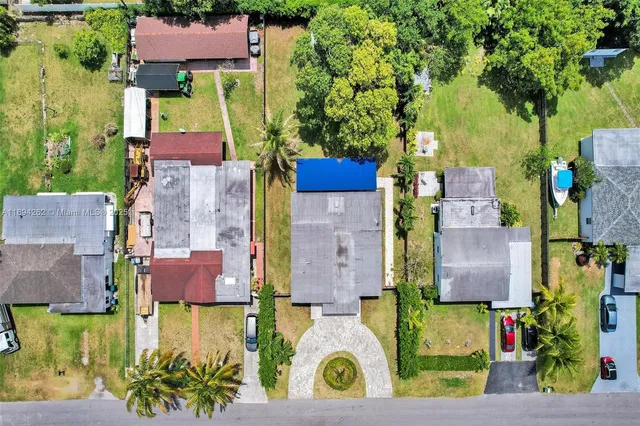 an aerial view of residential houses with outdoor space and street view