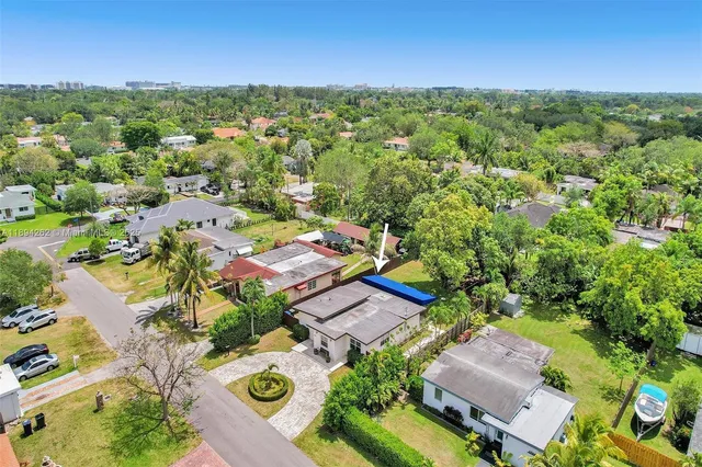 an aerial view of residential houses with outdoor space and street view
