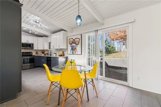 a view of a dining room with furniture and a window
