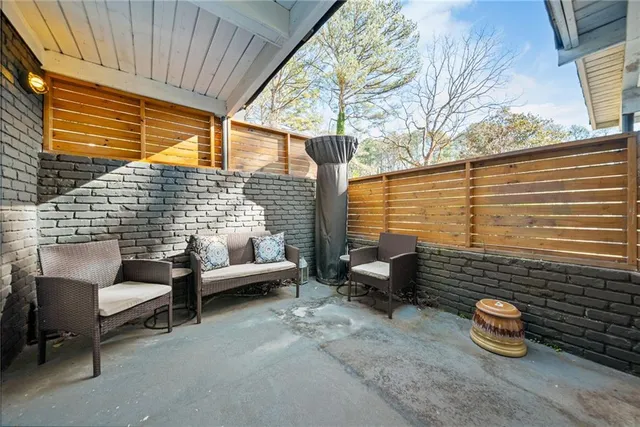 a balcony with couple of chairs and a couch