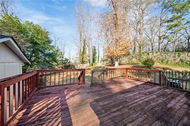 a view of balcony with wooden floor and fence