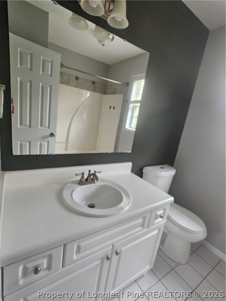 5708 Spreading Branch Road Hope Mills, NC 28348 - Photo 15 of 21 a bathroom with a sink toilet and mirror