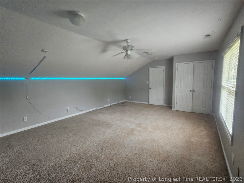 5708 Spreading Branch Road Hope Mills, NC 28348 - Photo 18 of 21 an empty room with windows and fan