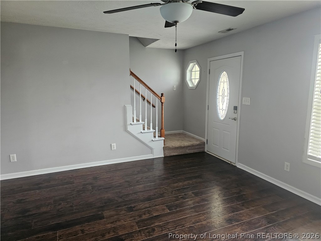 5708 Spreading Branch Road Hope Mills, NC 28348 - Photo 2 of 21 an empty room with wooden floor fan and windows