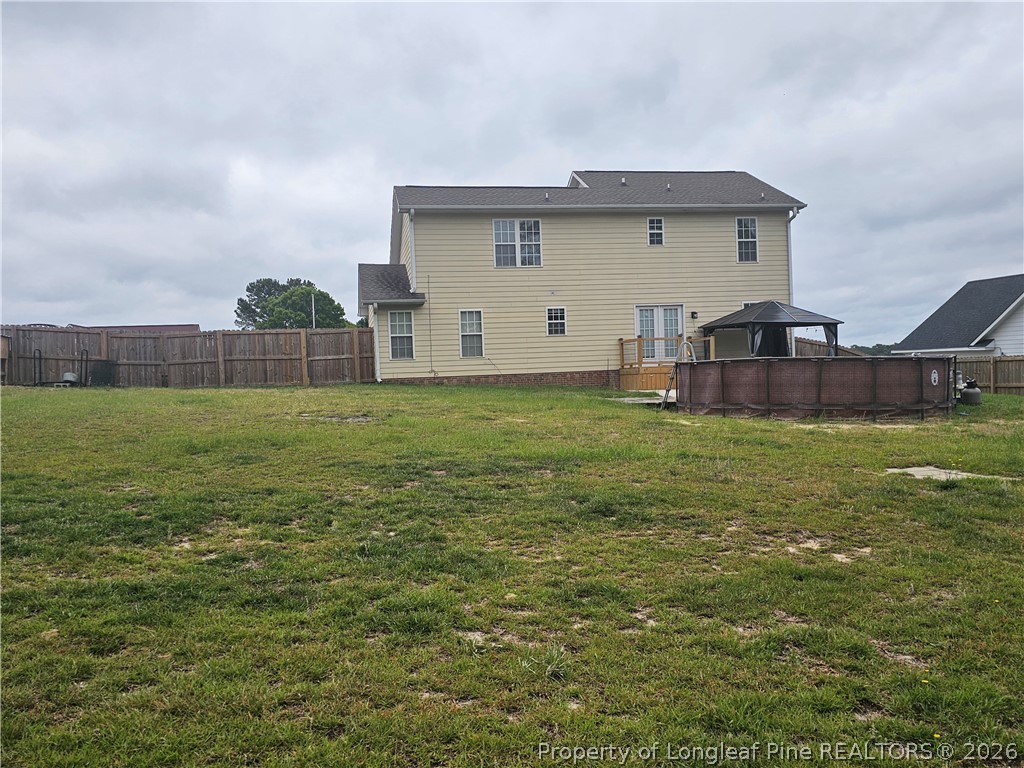 5708 Spreading Branch Road Hope Mills, NC 28348 - Photo 21 of 21 a view of a house with a backyard