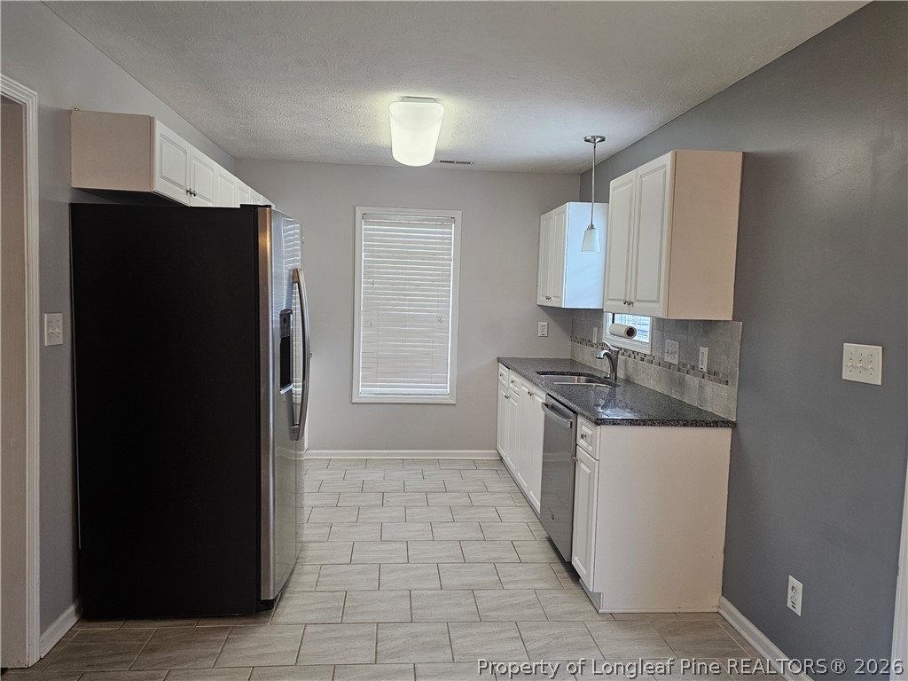 5708 Spreading Branch Road Hope Mills, NC 28348 - Photo 5 of 21 a kitchen with a refrigerator and a sink