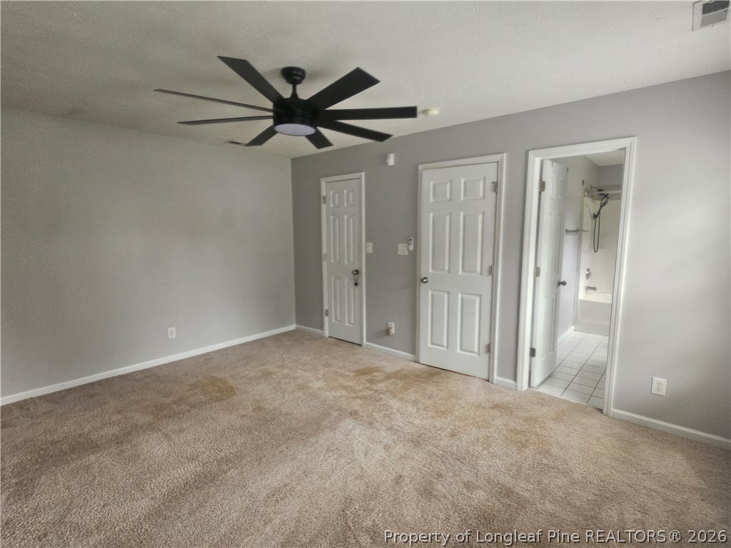 5708 Spreading Branch Road Hope Mills, NC 28348 - Photo 9 of 21 an empty room with closet and a chandelier fan