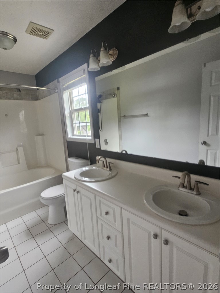 5708 Spreading Branch Road Hope Mills, NC 28348 - Photo 10 of 21 a bathroom with a sink a toilet and bathtub