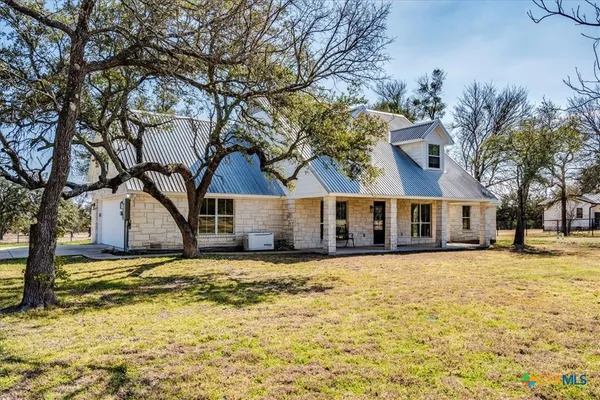 a large house with a large tree in front of house