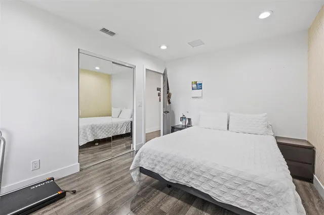 a bedroom with a bed and a night stand