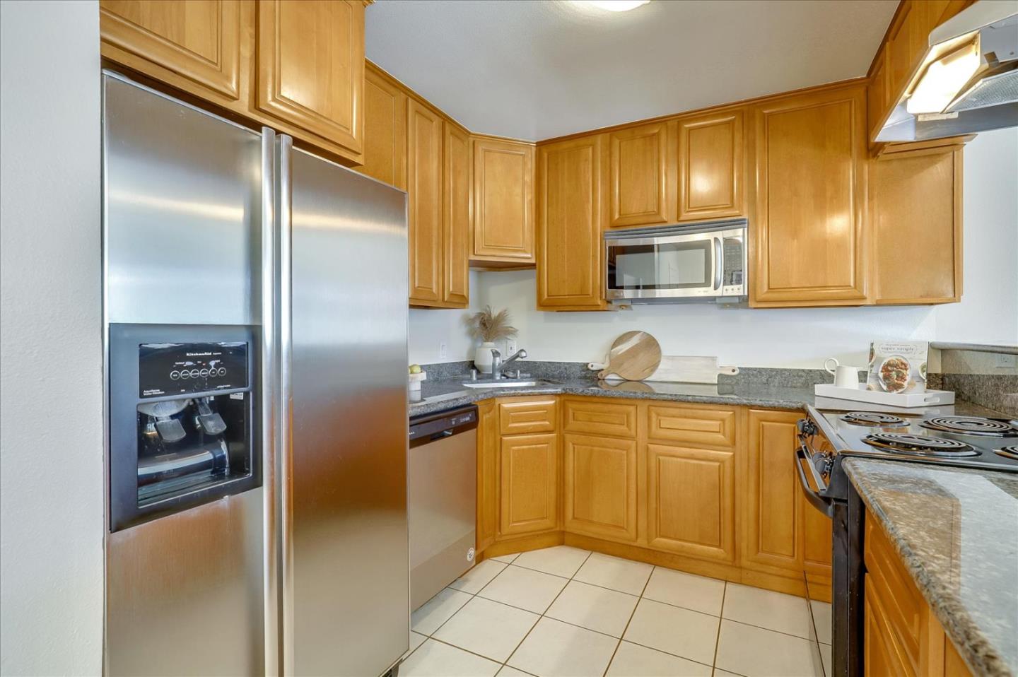 7 Embarcadero West, Unit 115 Oakland, CA 94607 - Photo 11 of 39 a kitchen with stainless steel appliances granite countertop a refrigerator and a stove top oven