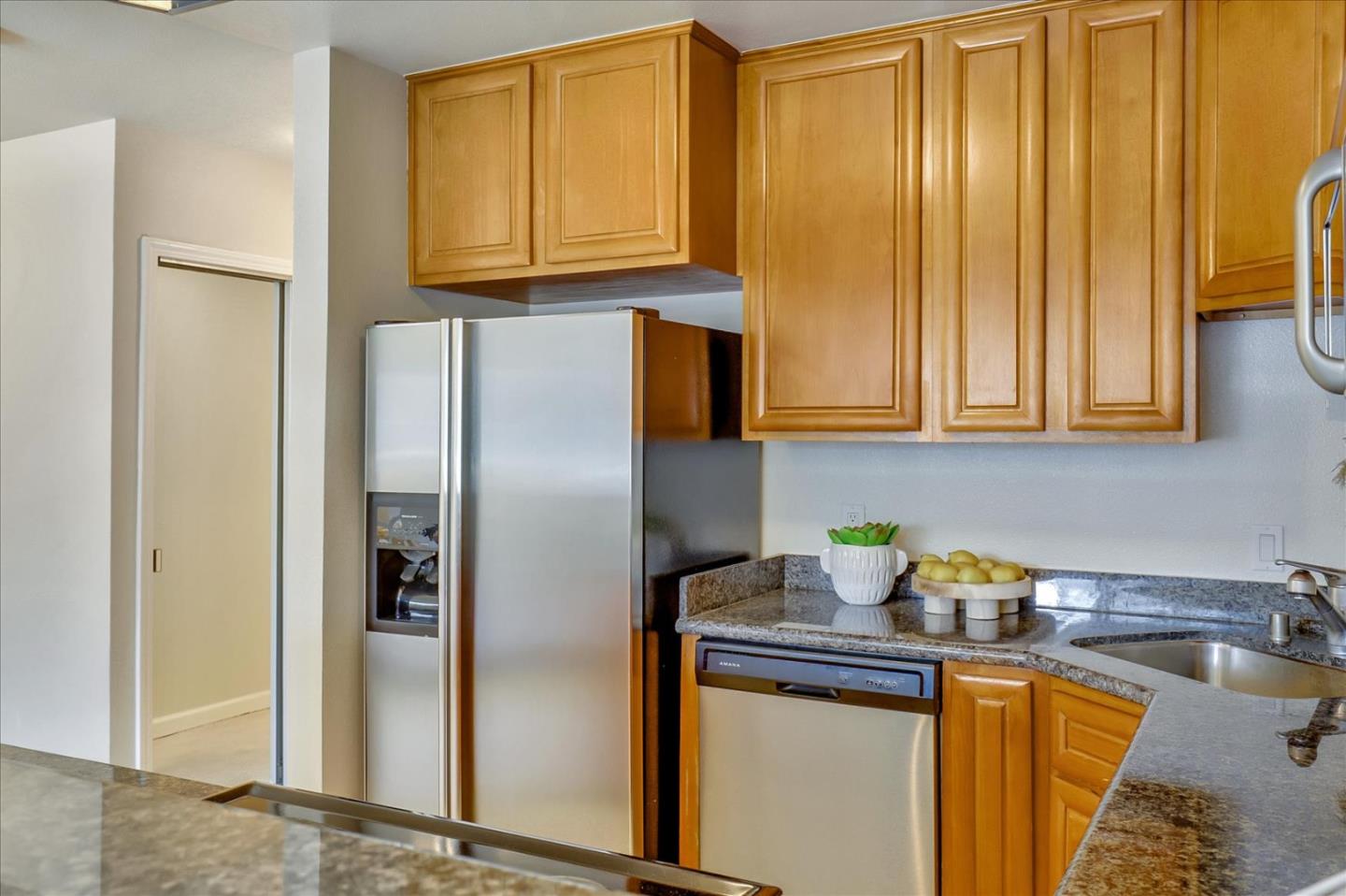 7 Embarcadero West, Unit 115 Oakland, CA 94607 - Photo 12 of 39 a kitchen with stainless steel appliances granite countertop a refrigerator and a sink