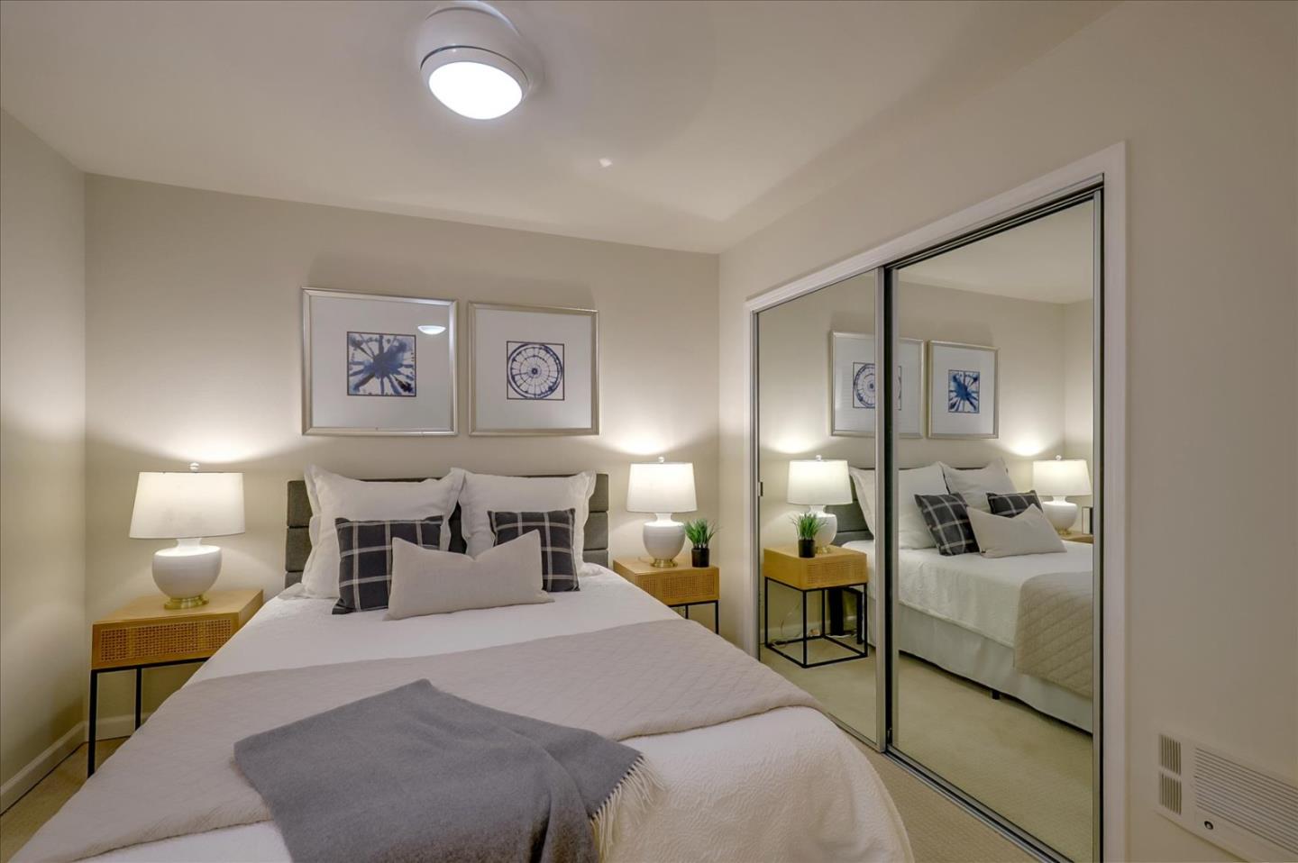 7 Embarcadero West, Unit 115 Oakland, CA 94607 - Photo 14 of 39 a bedroom with a bed and a large mirror