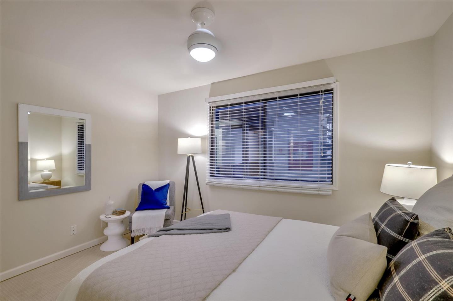 7 Embarcadero West, Unit 115 Oakland, CA 94607 - Photo 15 of 39 a bedroom with a bed and a chandelier