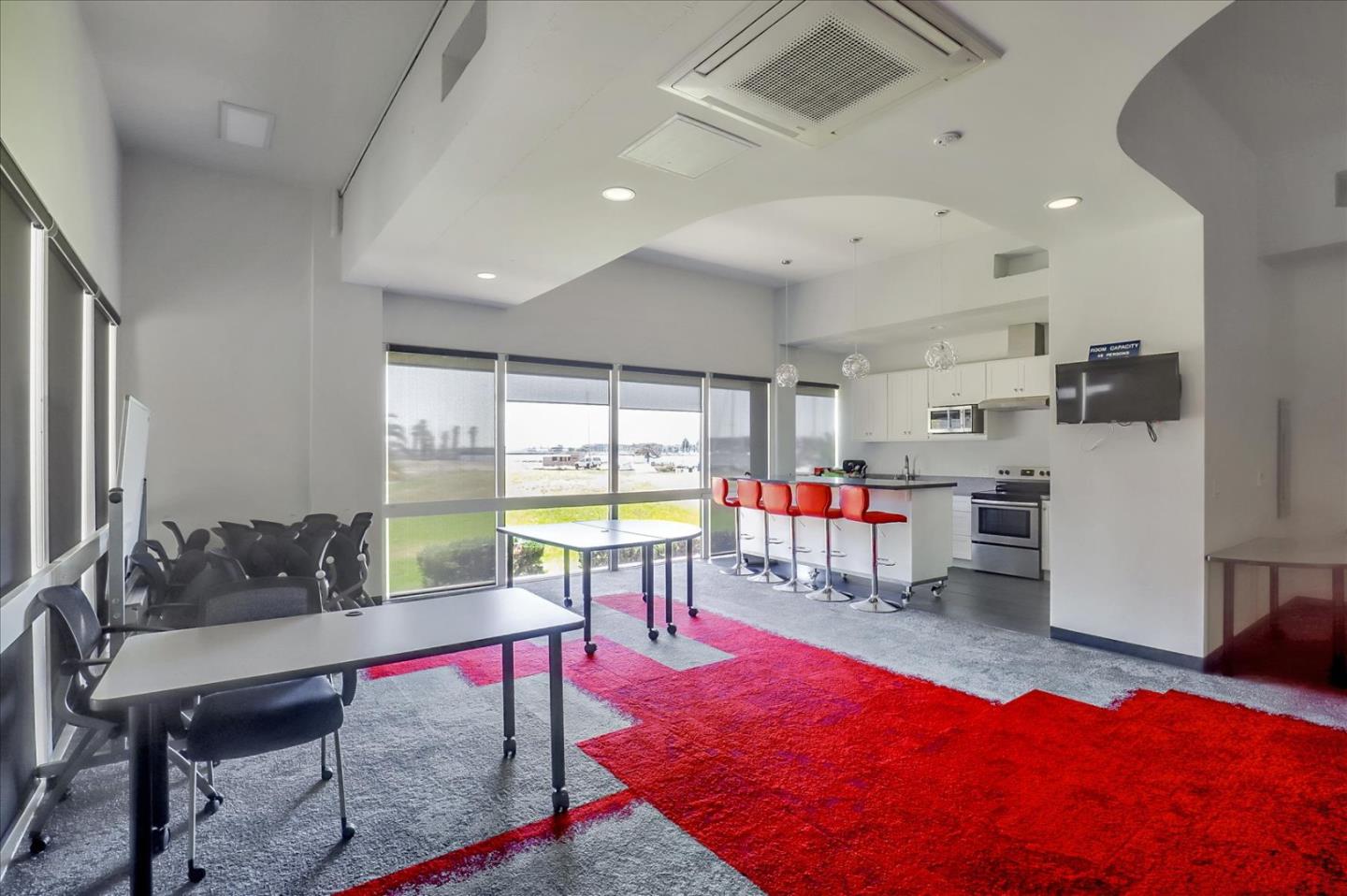 7 Embarcadero West, Unit 115 Oakland, CA 94607 - Photo 32 of 39 a living room with furniture a rug and white walls