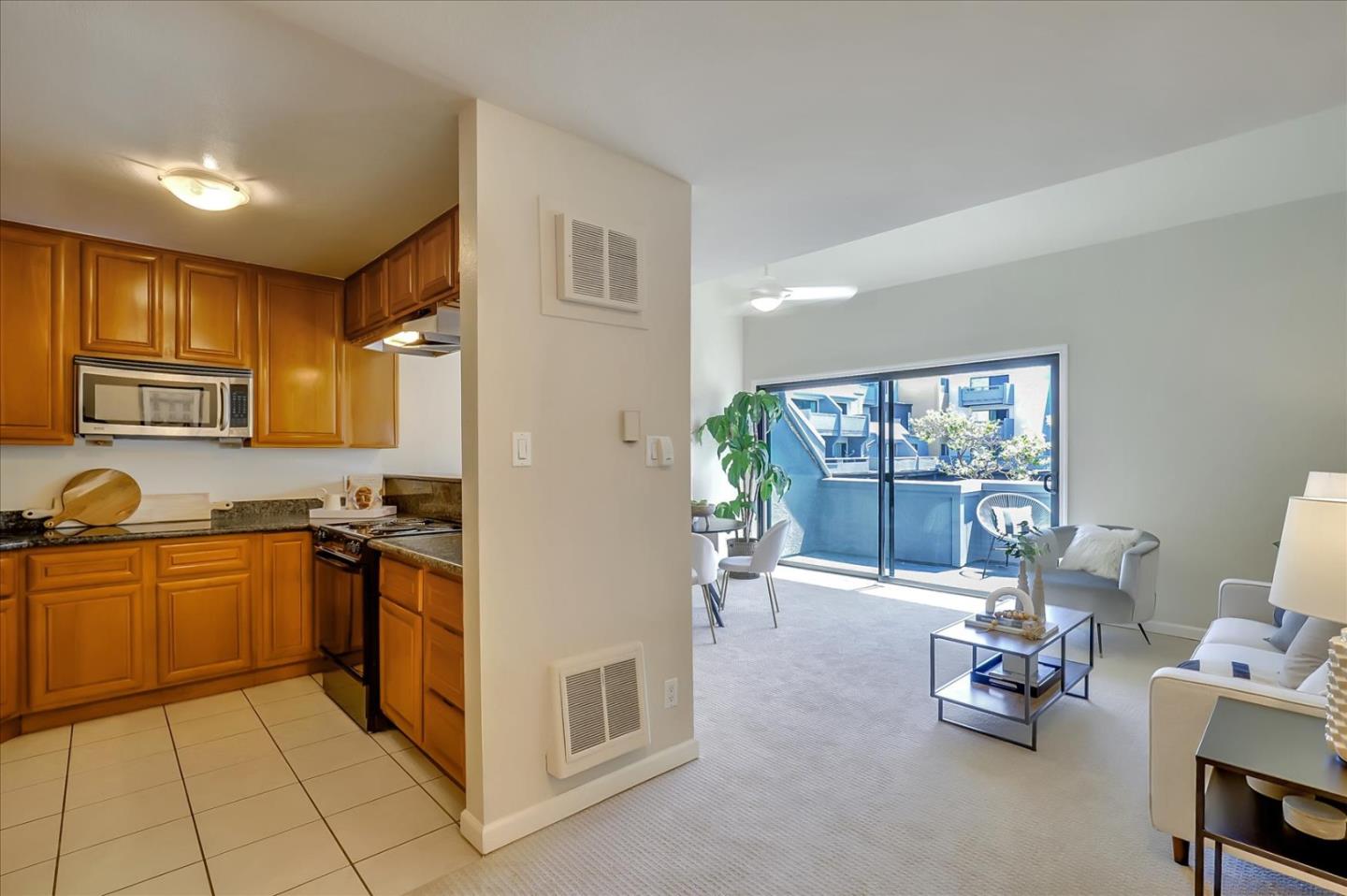 7 Embarcadero West, Unit 115 Oakland, CA 94607 - Photo 9 of 39 a kitchen with a sink and living room