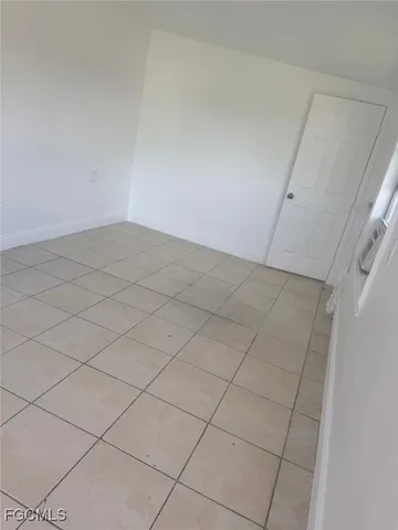 a kitchen with granite countertop white cabinets and refrigerator