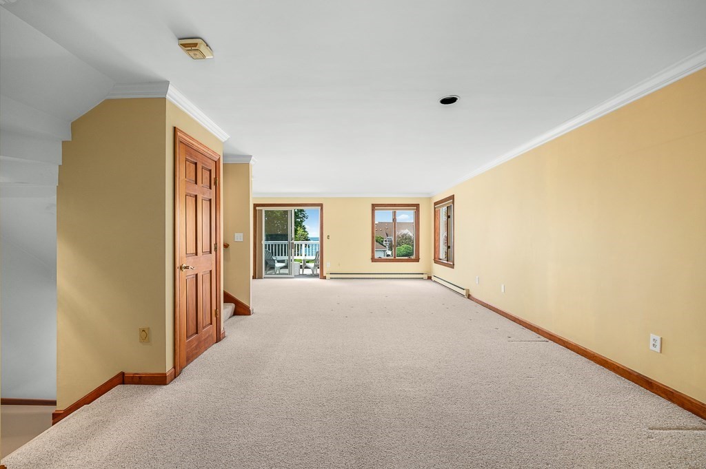 3 Raven Lane, Unit A2 Gloucester, MA 01930 - Photo 16 of 39 a view of a livingroom with wooden floor and a ceiling fan