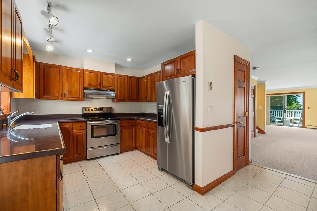 3 Raven Lane, Unit A2 Gloucester, MA 01930 - Photo 18 of 39 a kitchen with granite countertop a refrigerator and a sink