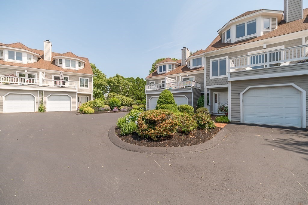 3 Raven Lane, Unit A2 Gloucester, MA 01930 - Photo 30 of 39 a front view of a house with a yard and garage