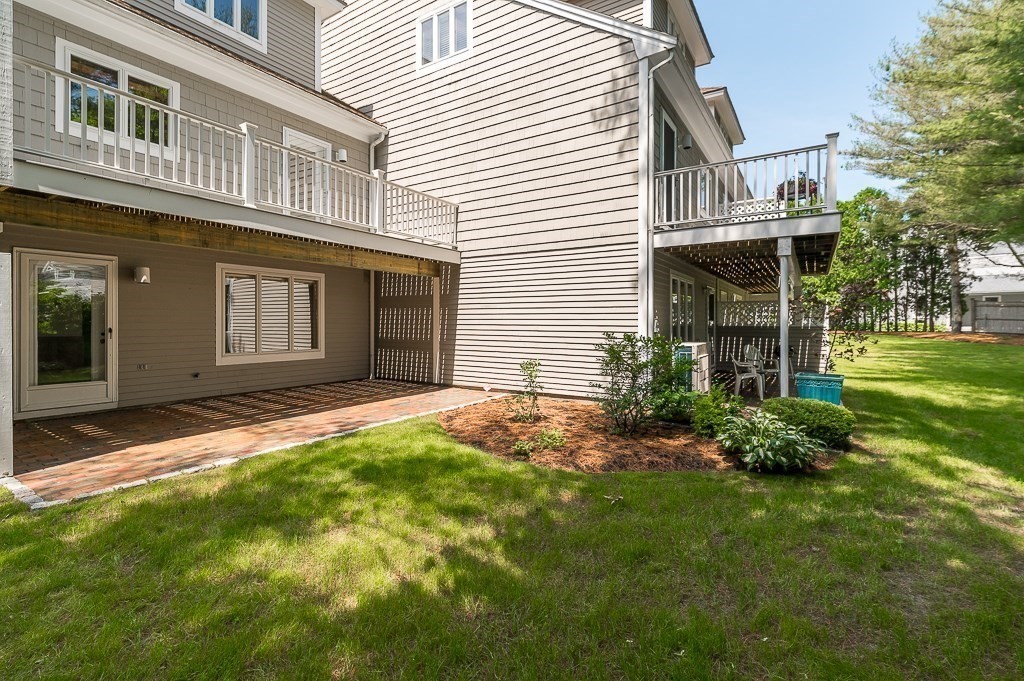 3 Raven Lane, Unit A2 Gloucester, MA 01930 - Photo 31 of 39 a front view of a house with a yard and garage