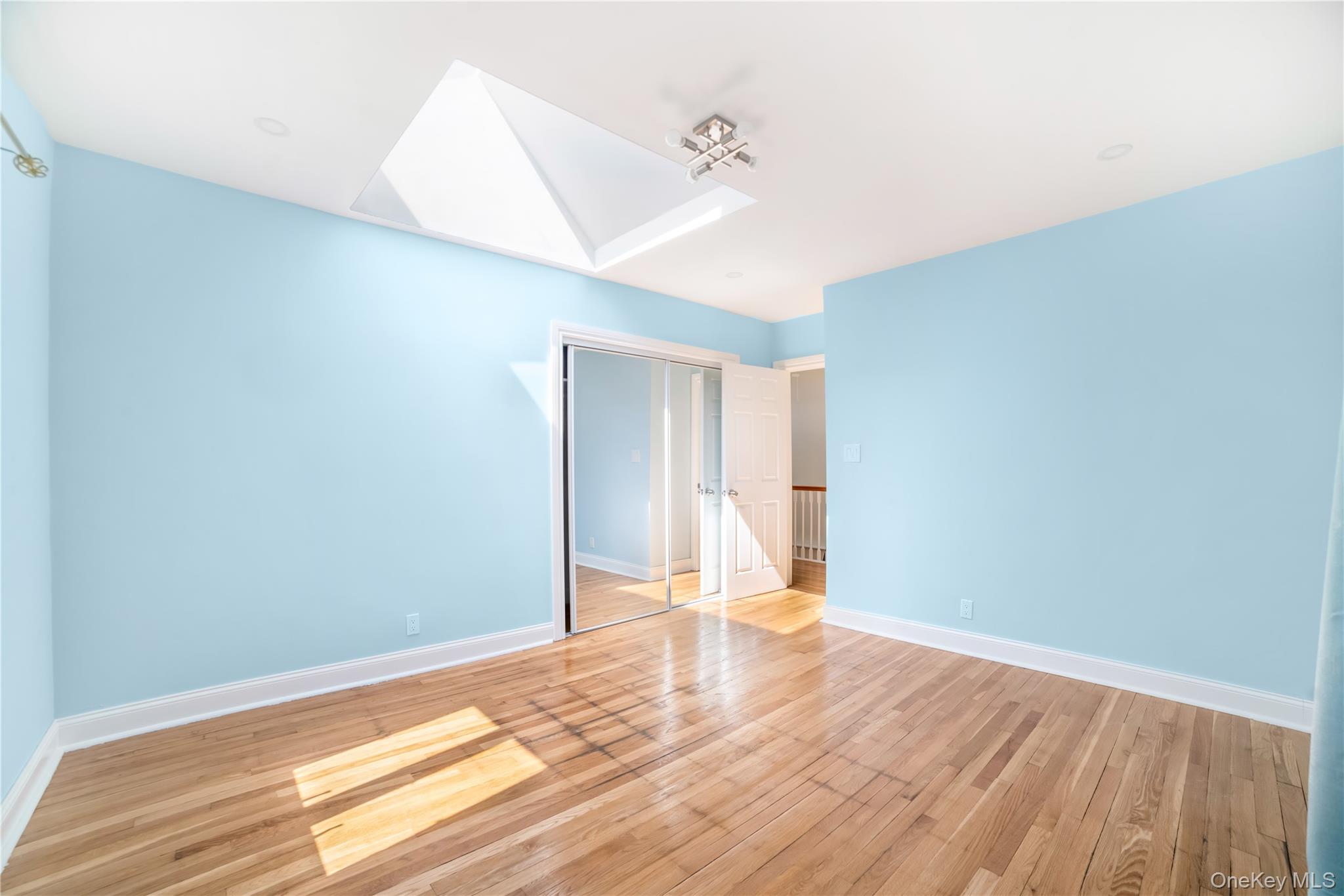 81-28 252nd Street Queens, NY 11426 - Photo 12 of 21 a view of a room with wooden floor and white walls