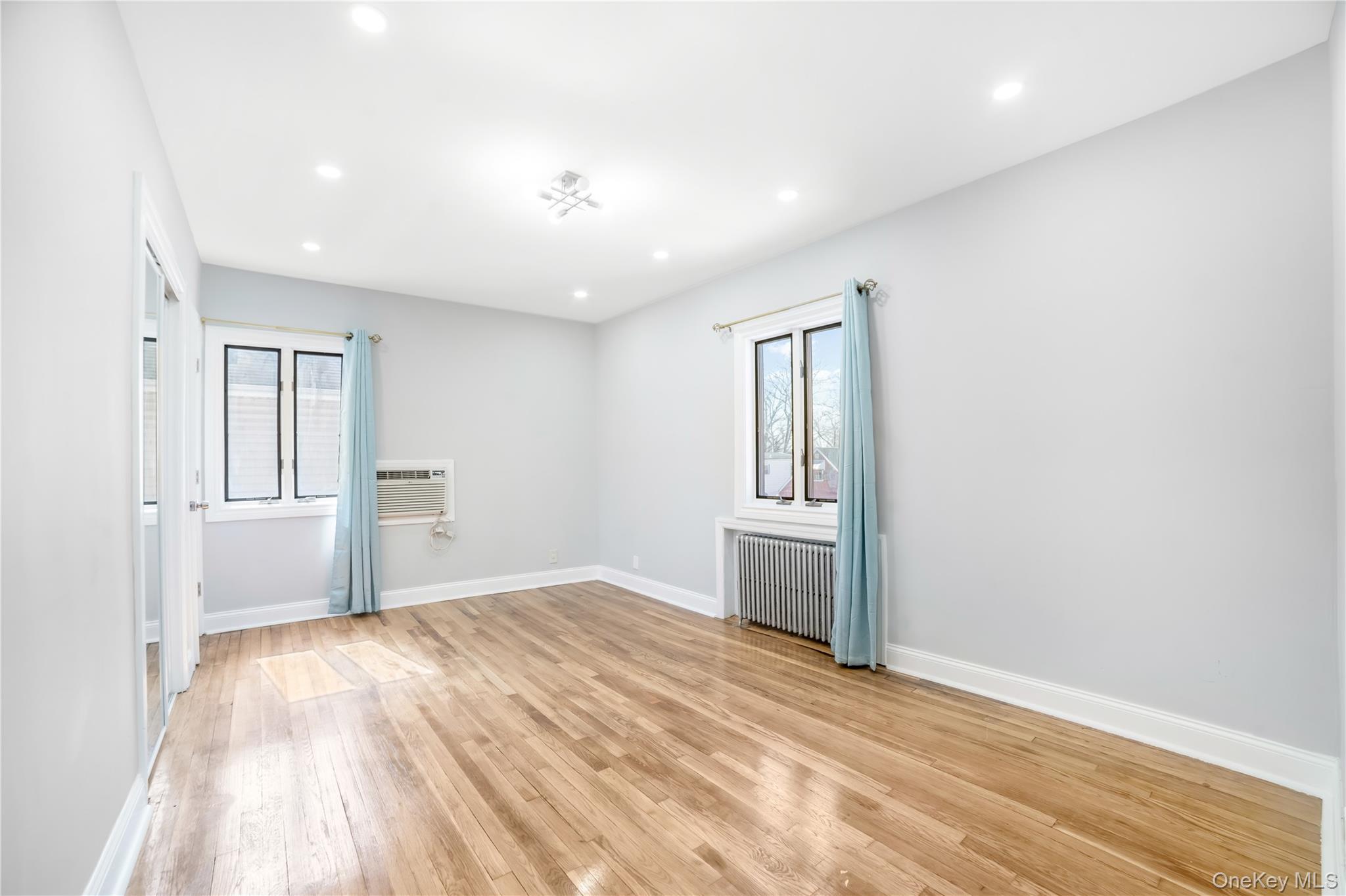 81-28 252nd Street Queens, NY 11426 - Photo 13 of 21 a view of empty room with wooden floor and fan