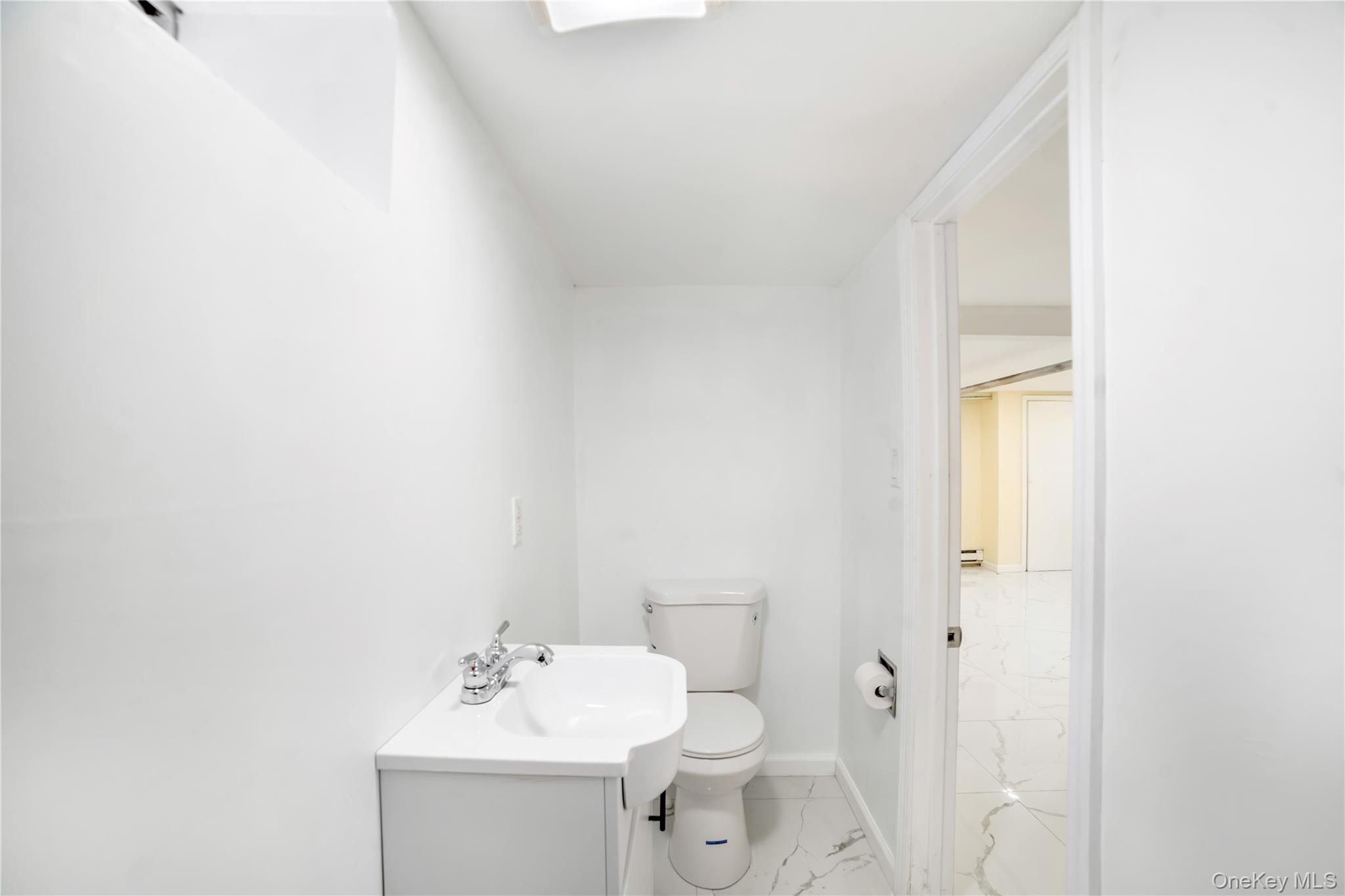 81-28 252nd Street Queens, NY 11426 - Photo 18 of 21 a bathroom with a sink and a mirror