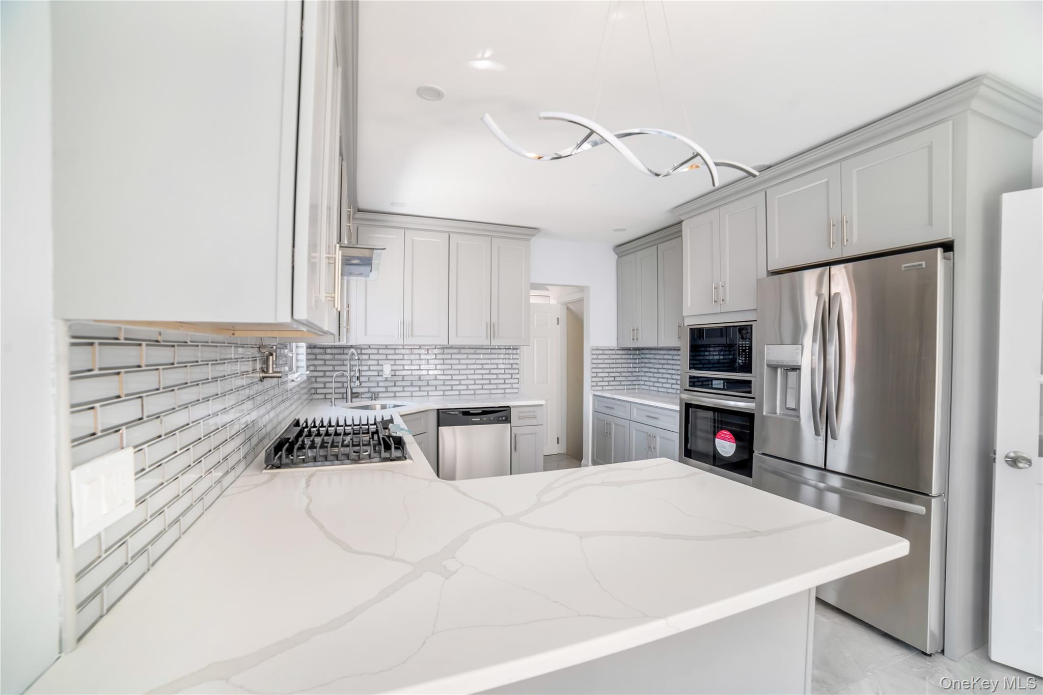81-28 252nd Street Queens, NY 11426 - Photo 6 of 21 a kitchen with stainless steel appliances a refrigerator sink and stove