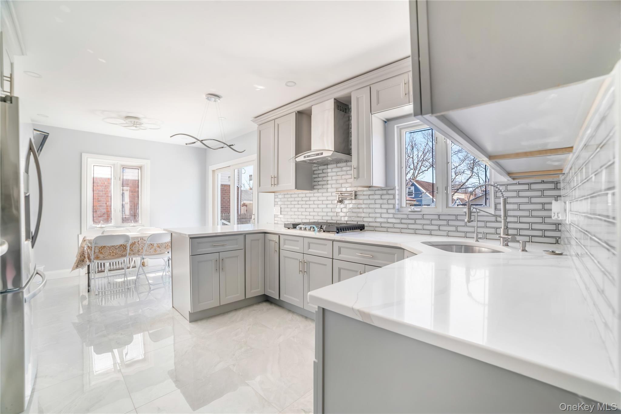 81-28 252nd Street Queens, NY 11426 - Photo 7 of 21 a kitchen with granite countertop a sink and white cabinets