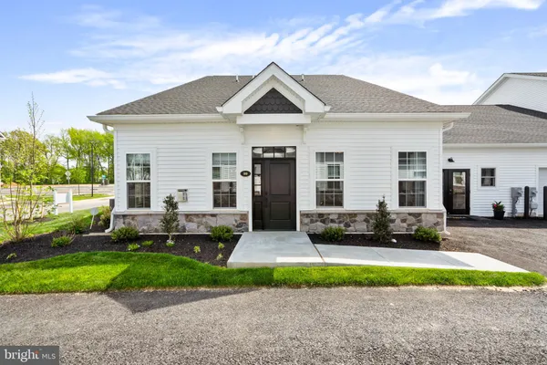 a front view of a house with a yard and outdoor seating