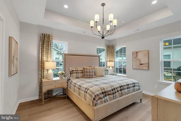 a bedroom with a large bed and a chandelier
