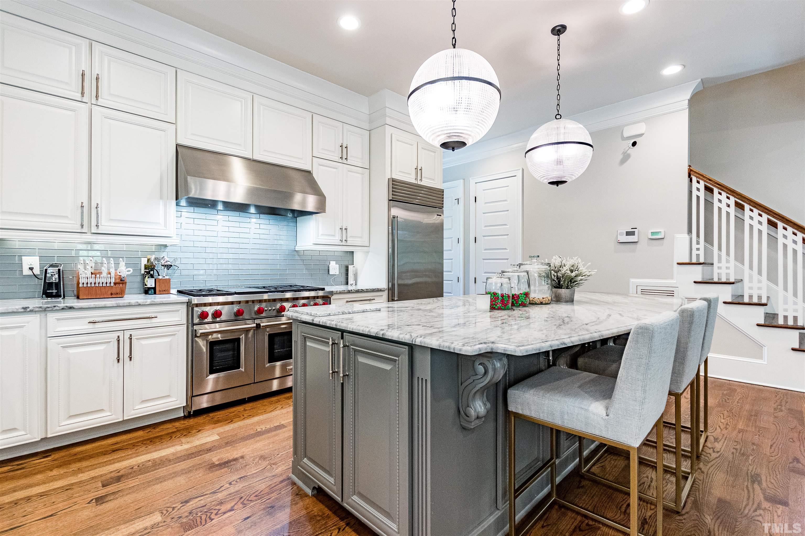 1928 Ridge Road Raleigh, NC 27607 - Photo 5 of 27 a kitchen with stainless steel appliances granite countertop a stove a sink dishwasher and a refrigerator with wooden floor