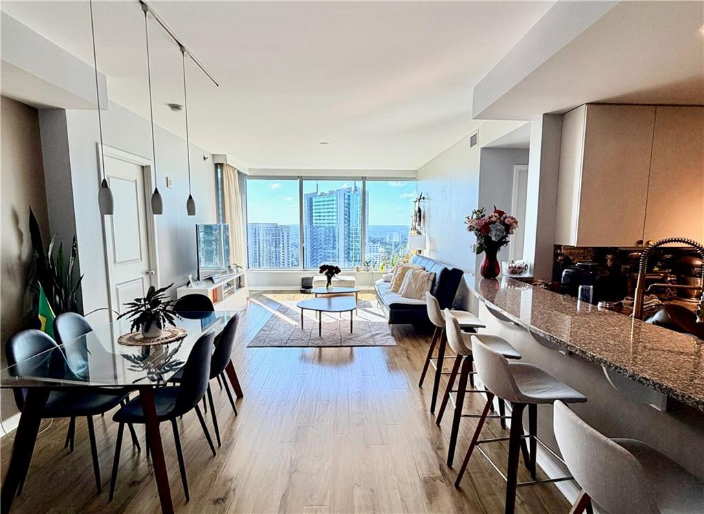 a view of a dining room with furniture and wooden floor