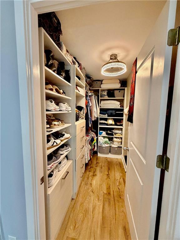 3338 Peachtree Road Northeast, Unit 2906 Atlanta, GA 30326 - Photo 12 of 27 a view of walk in closet with clothes and shoes