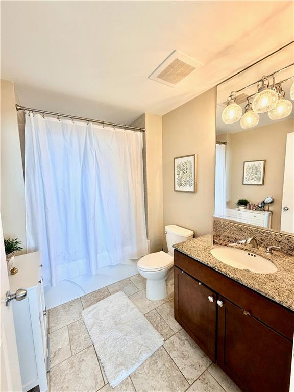 3338 Peachtree Road Northeast, Unit 2906 Atlanta, GA 30326 - Photo 13 of 27 a bathroom with a granite countertop sink toilet and shower